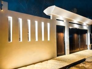 a wall with doors and lights on it at Casa Bonita PXM in Puerto Escondido