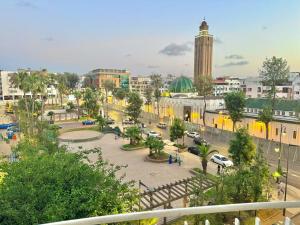 a city with a clock tower and a street at Spacious family accommodation in Rabat