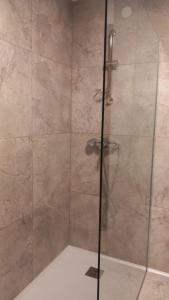 a shower stall with a glass door with a shower at Luketovi in Kostanjevica na Krasu