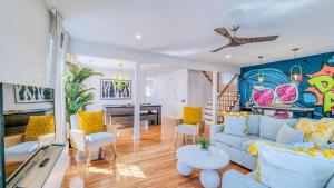 a living room with a couch and a table at Sunrise Playce-Designer Beach Retreat + Pool Table in Atlantic City