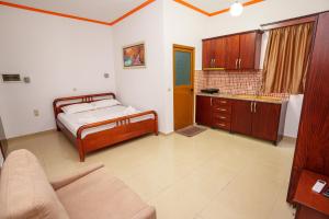 a bedroom with a bed and a couch in it at Vila Anna in Ksamil