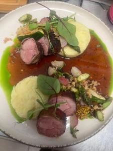 a plate of food with meat and vegetables on it at Krakowska 39 in Kazimierz Dolny