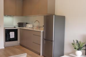 a kitchen with a stainless steel refrigerator and appliances at Studio Flat Above MK Station in Milton Keynes +10 photos