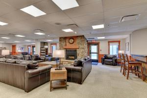 a large living room with leather furniture and a fireplace at Wedgewood Lodge in Breckenridge