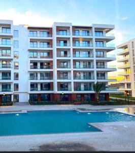 an apartment building with a swimming pool in front of it at Sea breeze Park residens 2 in Baku