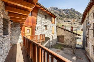 a balcony of a building with a wooden deck at Champex Apartments in Pré-Saint-Didier