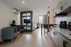 a kitchen and living room with a table and chairs at Nomadic Boutique Living and Experience Center in Medellín +60 photos