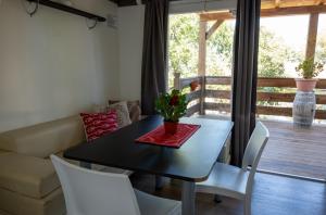 a dining room with a table and chairs and a couch at Redabba House in Arzana +13 photos