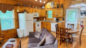 a living room with a couch and a table in a kitchen at A Painted Pony in Sevierville
