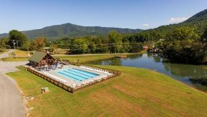 an overhead view of a swimming pool next to a river at A Painted Pony in Sevierville