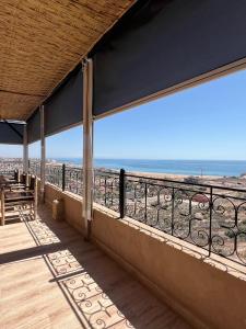 a balcony with a view of the ocean at SurfAppart Morocco in Tamraght Ouzdar