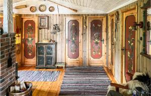 a room with wooden doors and a rug at Cozy Home In Nissedal in Solli +8 photos