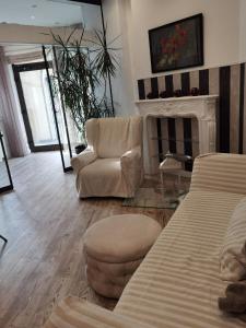 a living room with a couch and chairs and a fireplace at Alte Bank in Rödental