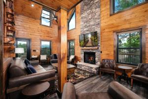 a living room with a fireplace in a log cabin at Saving Grace Where the Mountains Save the Day in Pigeon Forge
