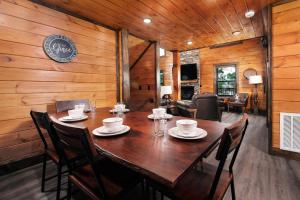 a wooden dining room with a table and chairs at Saving Grace Where the Mountains Save the Day in Pigeon Forge +31 photos