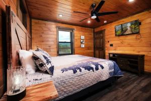 a bedroom with a bed and a ceiling fan at Saving Grace Where the Mountains Save the Day in Pigeon Forge