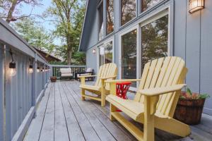 two rocking chairs sitting on a porch at Fireplace Fire Pit Covered Porch & Resort Access in Hedgesville