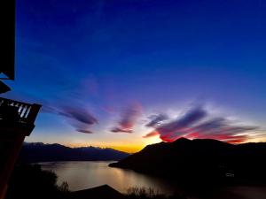 a view of a sunset over a body of water at Villa Diomira in Cannobio
