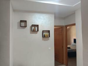a room with a bed and two pictures on the wall at Le Refuge de Vittel 5 in Ifrane