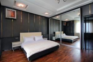 a bedroom with a large bed and a mirror at 3х комнатная 2 спальни Арбат ЖК Столичный центр in Almaty +54 photos