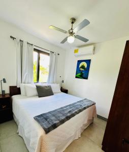 a bedroom with a bed with a ceiling fan at T4 - 2BR Eco Tiny Home Near the Beach by Veritas Pacifica in San Diego +9 photos