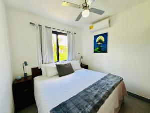 a bedroom with a bed with a ceiling fan at T4 - 2BR Eco Tiny Home Near the Beach by Veritas Pacifica in San Diego