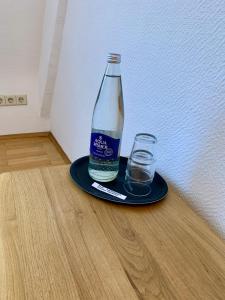 a bottle and two glasses on a plate at Hotel Zum Pfalzgrafen in Heidelberg +16 photos