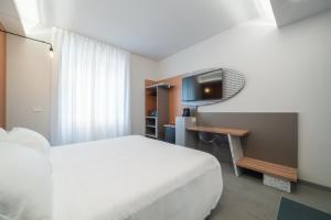 a hotel room with a bed and a television at Brera Guest House in Milan