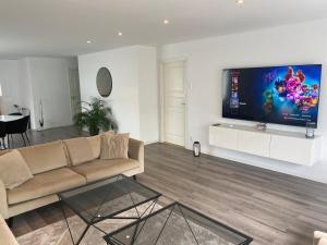 a living room with a couch and a flat screen tv at Villa Åstorp in Åstorp