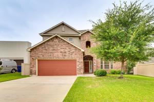 a brick house with a garage and a tree at 7 Mi to Lake Casa Blanca Laredo Family Home! in Laredo