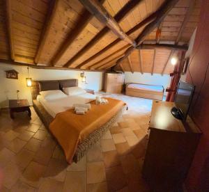 a large bedroom with a large bed in an attic at Zest House in Santa Venerina