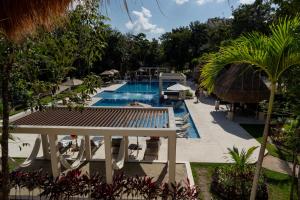 a view of a pool at a resort at Custom decor-sleeps 6 with 2 pools- Condo near beach-Puerto Morelos Mexico,Casa Yellowstone in Puerto Morelos