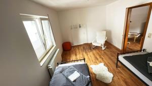 ein kleines Schlafzimmer mit einem Bett und einem Spiegel in der Unterkunft Stay & Relax Apartment in Flörsheim am Main in Flörsheim + 3 Fotos