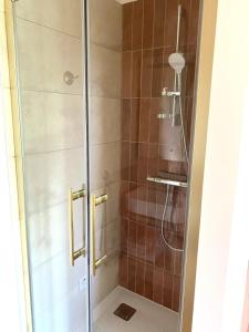 a shower with a glass door in a bathroom at Inspired space in Le Mans