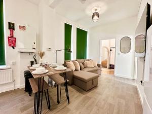 a living room with a couch and a table at Chic & Modern 2BR Apartment - Luxury Manchester Retreat in Manchester