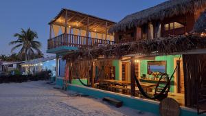 a building on the beach with a resort at Casa Awakening, Beach-front in El Cuyo
