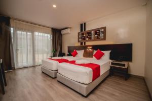 a large bedroom with a large bed with red pillows at Ramada Encore - Labasa Damodar City in Labasa