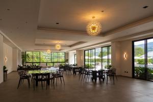 a banquet hall with tables and chairs and a chandelier at Casa Noral Hotel in Copacabana