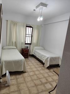a bedroom with two beds and a window at Cerro del sol, habitaciones privadas in Salta