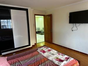 a living room with a bed and a flat screen tv at Appartement trouville in Aïn El Turk
