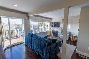 a living room with two couches and a fireplace at The Newport Lofts - 617 Thames Street in Newport