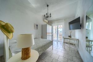 a bedroom with a bed and a table with a lamp at VILA SENTIO MARE-Apartments Livaić Željko in Pirovac