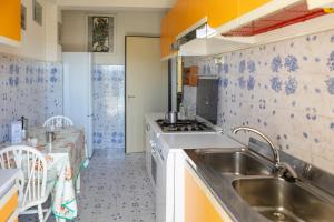 a kitchen with a sink and a stove at Frontemare - Casa Casoni in Marcelli +12 photos
