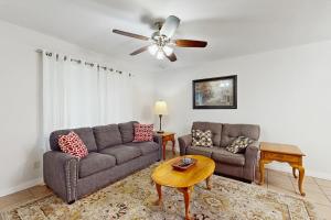 a living room with a couch and a table at Arroyo Haus in Fredericksburg
