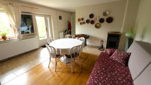 a living room with a table and a couch at Country House Trnac in Tuhelj