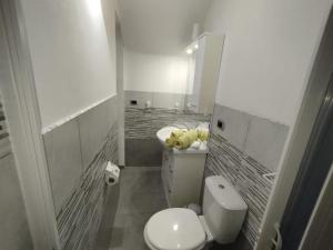 a small bathroom with a toilet and a sink at The Cordari House in Siracusa
