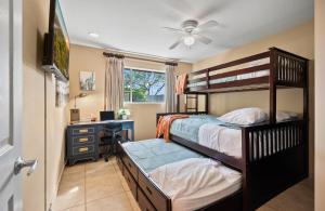 a bedroom with two bunk beds and a desk at Spacious Home with Games Hot Tub and Backyard Fun in Scottsdale +59 photos