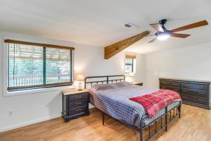 a bedroom with a bed and a ceiling fan at 2 Mi to Buffalo River Peaceful Family Retreat 