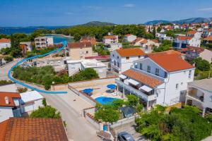 an aerial view of a town with a pool and houses at VILA SENTIO MARE-Apartments Livaić Željko in Pirovac