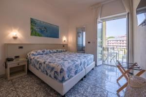 a bedroom with a bed and a balcony at Hotel Riviera in Deiva Marina +58 photos